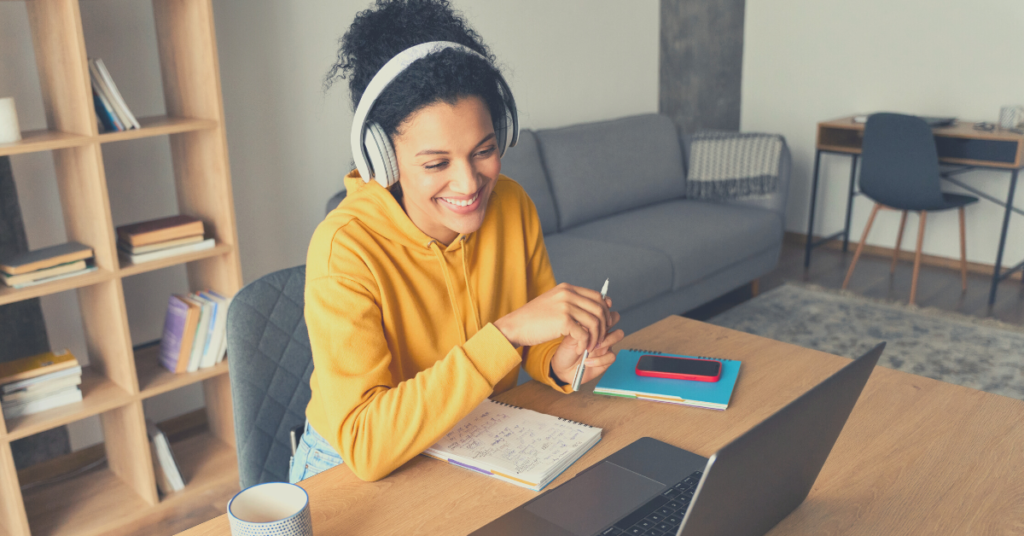 A woman at a desk enjoying a virtual meeting